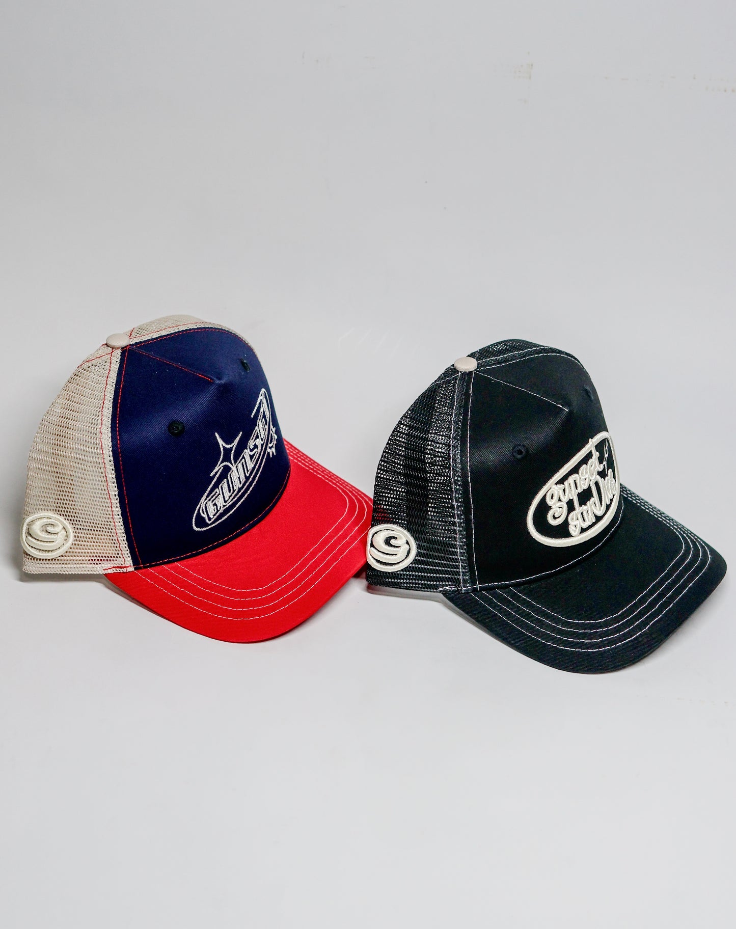 BLACK WITH WHITE STITCHING TRUCKER HAT